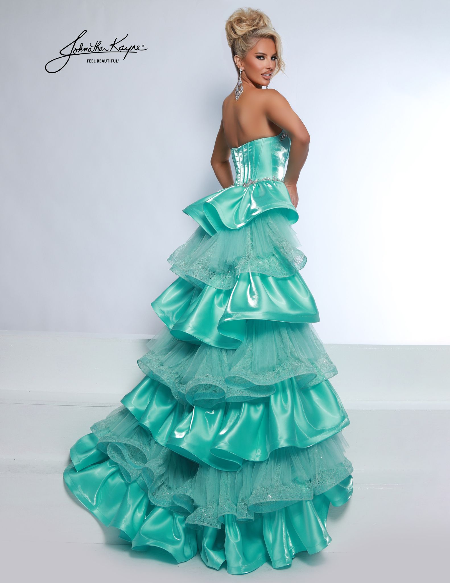 Back view of aqua strapless ruffle gown with tiered satin and tulle overskirt - glamourous pick for pageants or competitions.